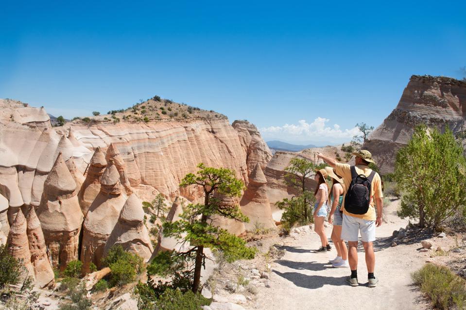 Family on vacation hiking trip in beautiful mountains.