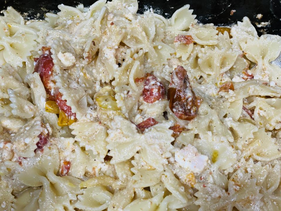 Farfalle pasta is mixed with baked Feta cheese and roasted cherry tomatoes to make a homemade meal that lives up to the hype.