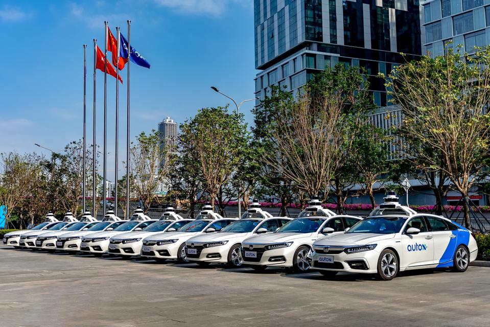Ten AutoX autonomous Honda sedans parked side-by-side.
