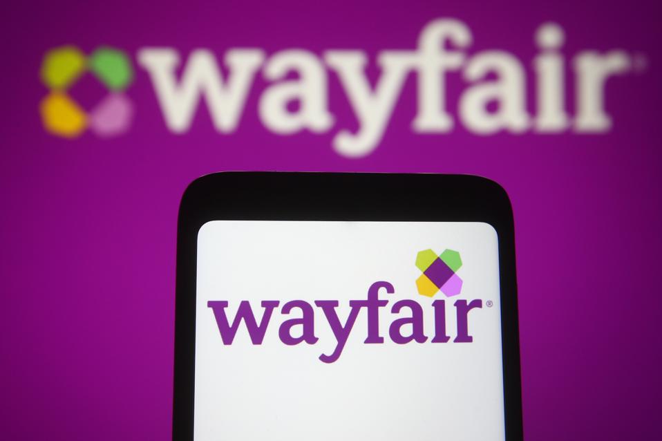 In this photo illustration, the Wayfair logo of the US e-...