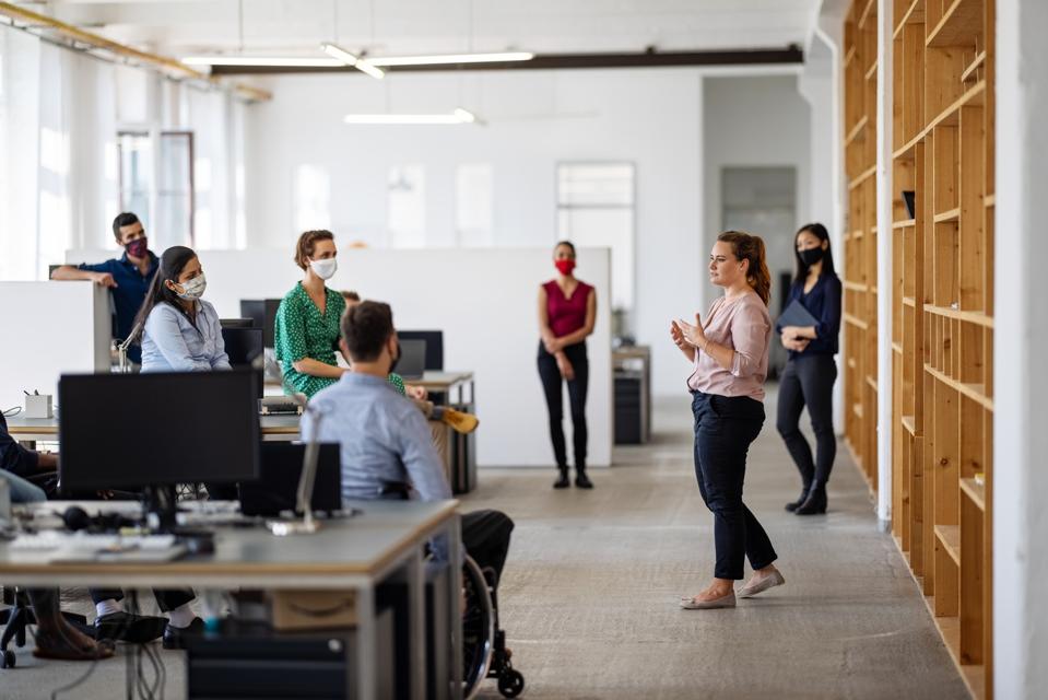 Business team having a meeting post-pandemic reopen