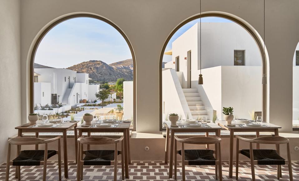 The dining room at Parilio hotel on Paros, Greece, has big arched windows 