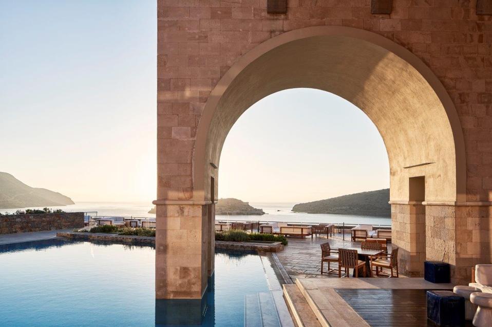 A dramatic arch extends into the pool at Blue Palace Elounda hotel on Crete, Greece