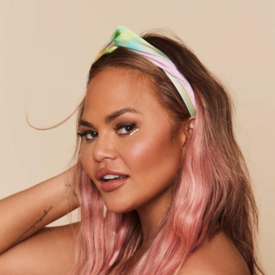 a woman with pink brunette hair wearing a silk hairband