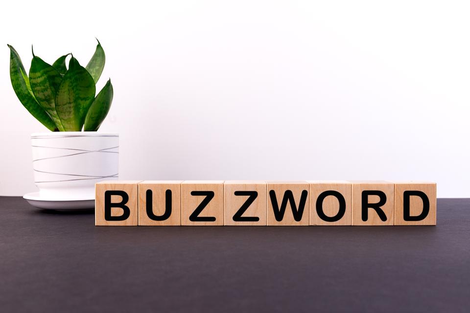 The word ″BUZZWORD″ made with building blocks on a light background