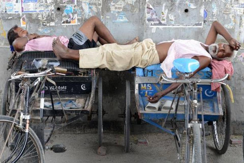 Indian men resting on their petty cabs