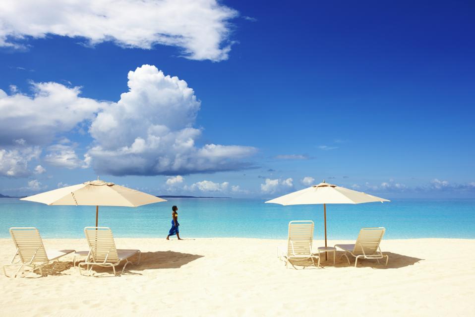 Woman walking on beach in Anguilla.