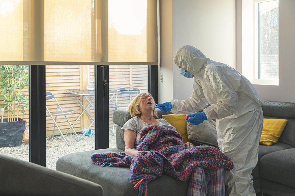 Senior woman having a test for covid-19 in her home