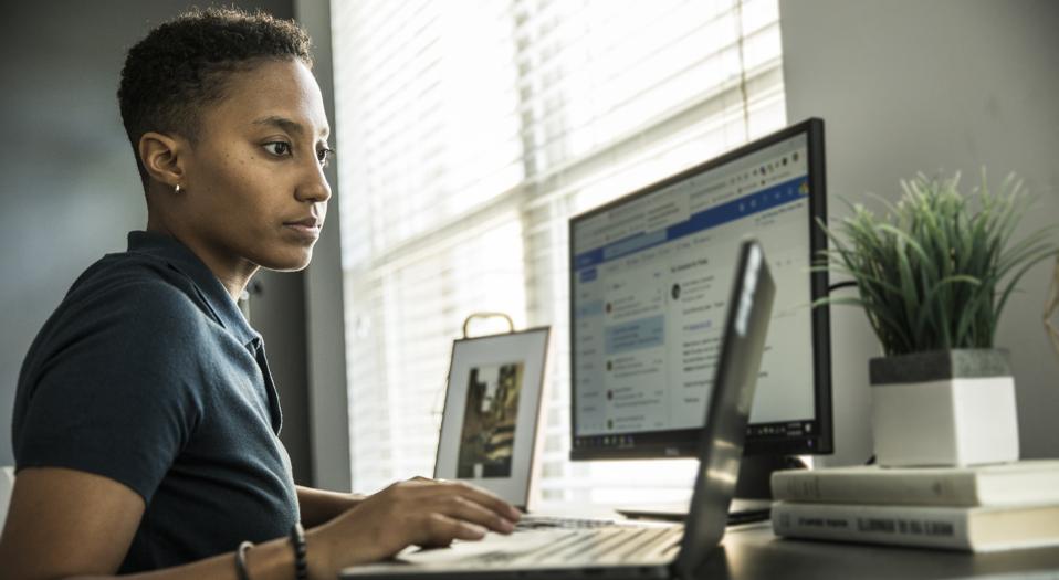 Young woman working on desktop computer at home