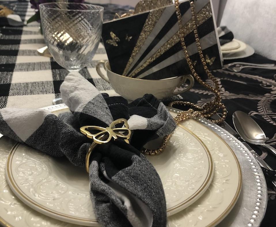 Elizabeth Sutton Brass Napkin Rings on check napkins on a plate