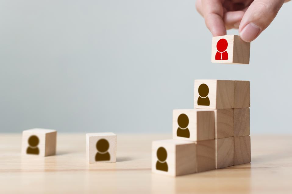 Human resources and talent management and recruitment business concept, Hand putting wood cube block on top staircase, Copy space