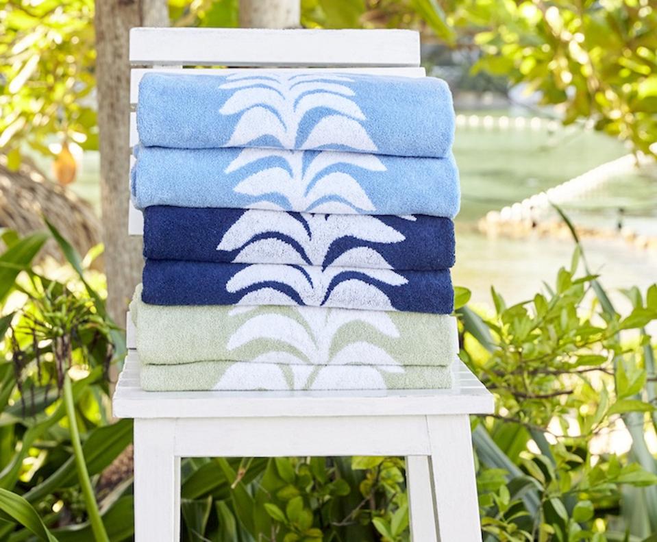 Weezie x Heather Chadduck Beach Bundle Beach towels on a chair with leaves in the backgorund