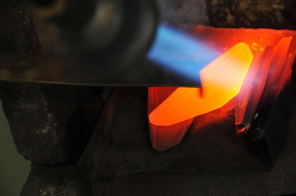 An Aston Martin badge is made