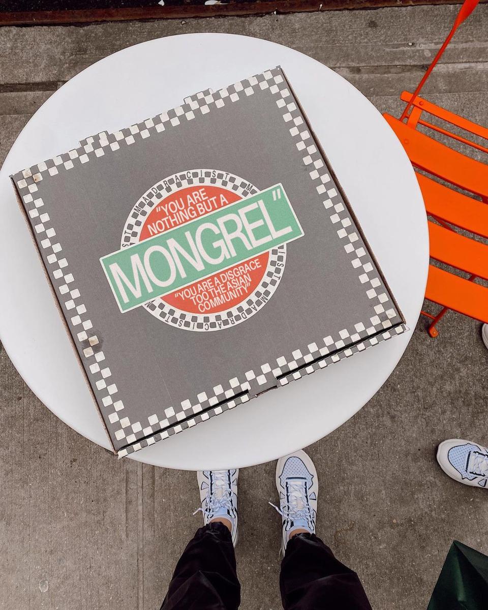 A pizza box with racist language photoshopped onto it