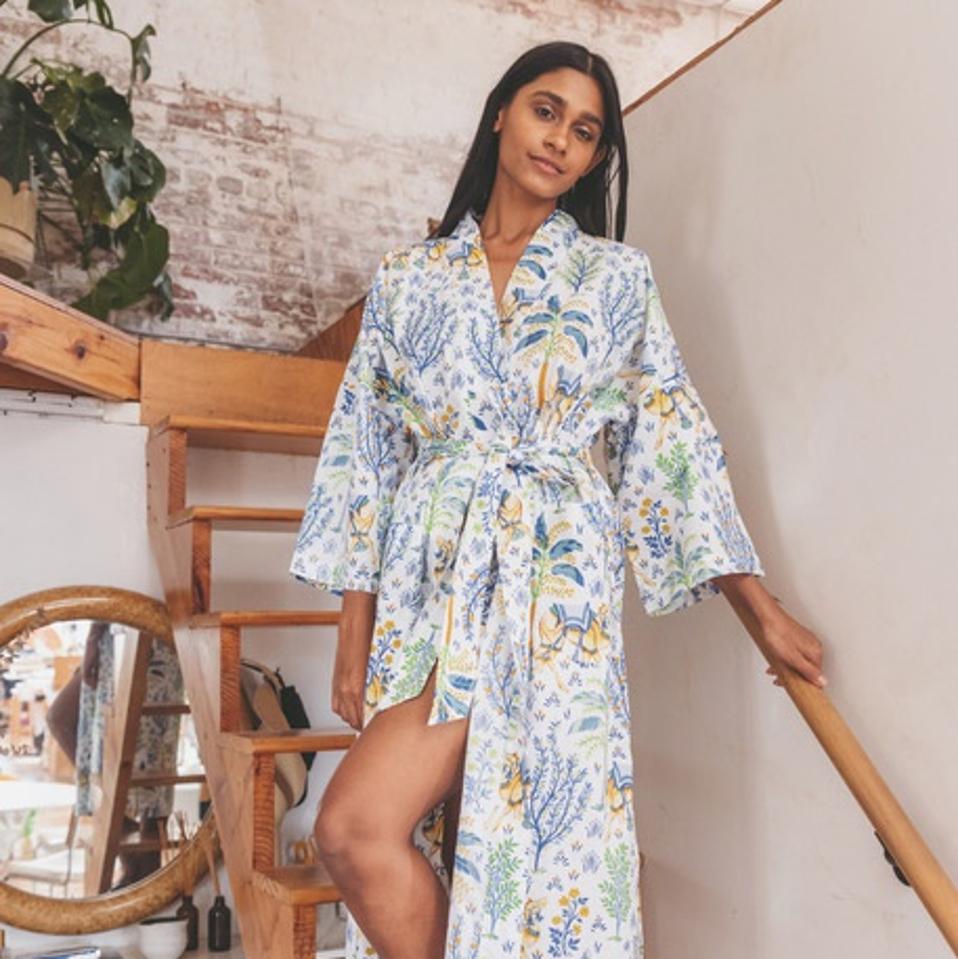 A woman wears a Printfresh robe in Camel's Courtyard.