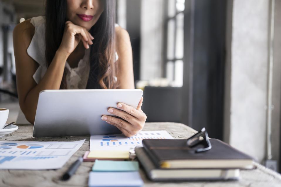 Businesswoman analyzing investment marketing data