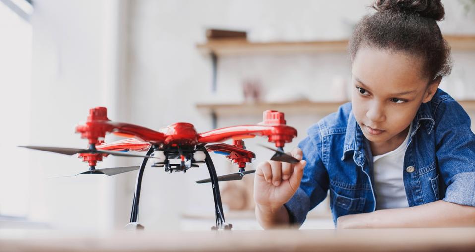 Female student learning how to use a drone