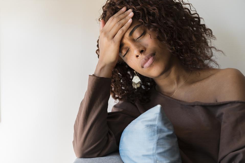 Woman with headache holding her head