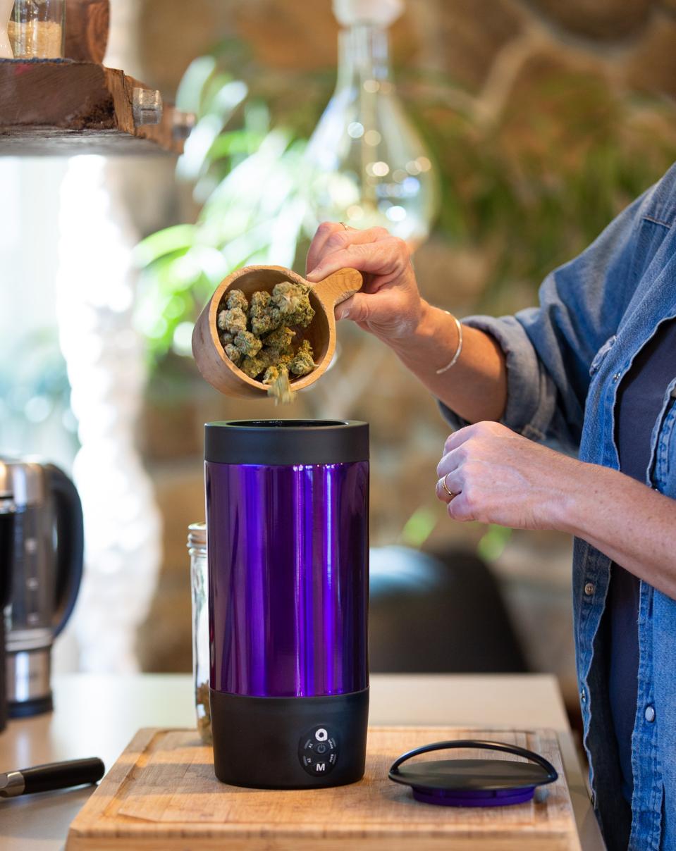 Cannabis being poured into the Ardent FX infusing and baking device.