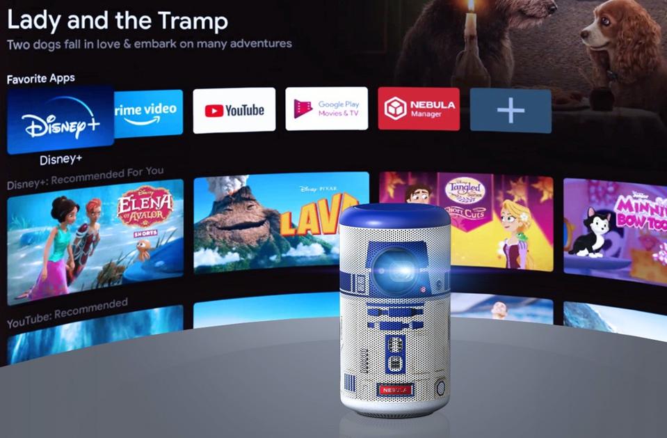 Nebula Capsule II R2-D2 projector in from of a a screen showing Google Android TV 9