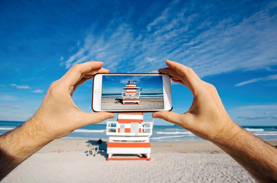 Taking pictures with smartphone at Miami Beach, personal perspective view