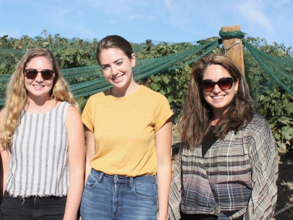 winemaker and daughters in vineyard