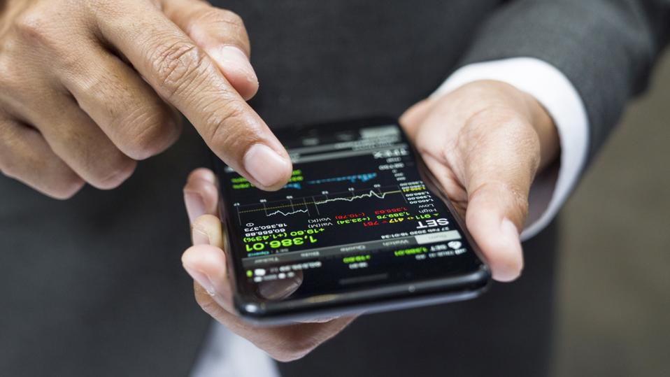Manager buying cryptocurrency through mobile phone app