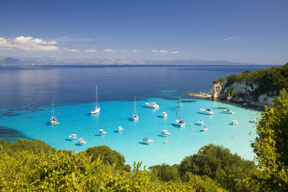 View across turquoise sea at Voutoumi Bay, Antipaxos, Greece