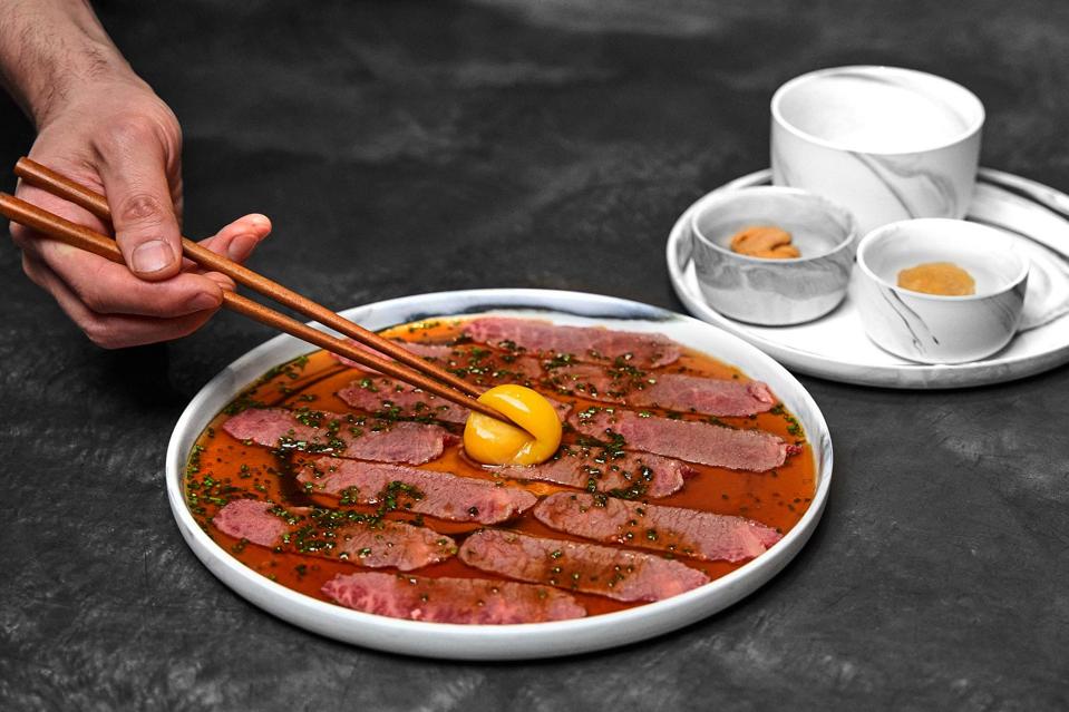 the plated sam-hap from oiji with egg yolk and soy sauce and lots of chives.