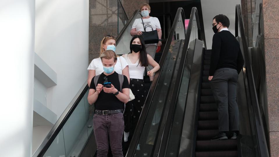 Shoppers on an escalator at a Manhattan shopping mall on May 13, 2021.