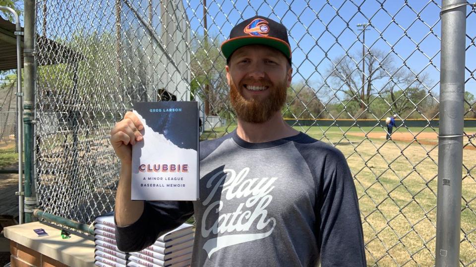 Clubbie author Greg Larson with a copy of his book.