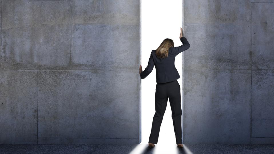 Businesswoman Pushing Open Concrete Walls