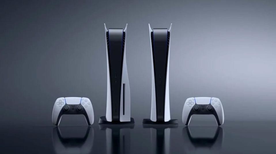 PS5 standing next to a PS5 digital edition with a pair of DualSense gamepads