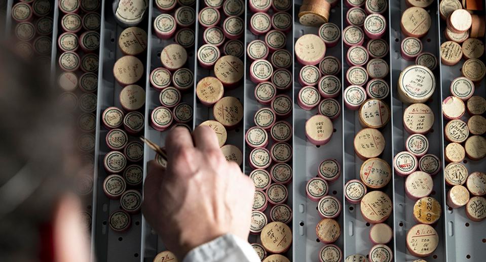 Watchmakers traditionally keep tiny movement components in small round boxes. Vacheron Constantin has a large inventory of vintage watch parts.