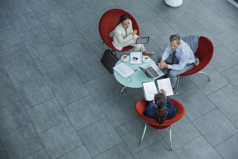 Businesspeople discussing strategy at coffee table