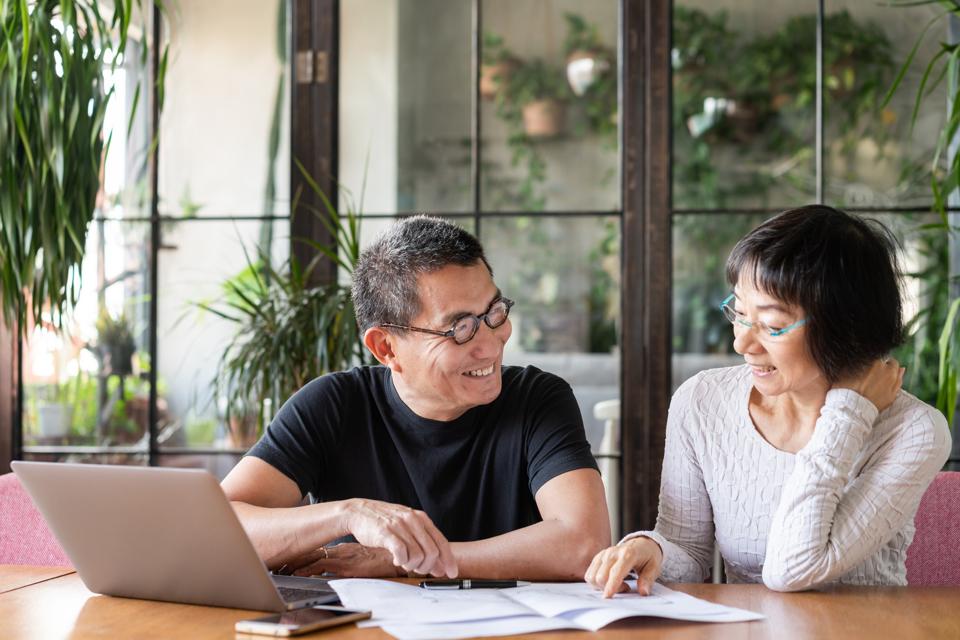 Asian couple talking about buying a new house