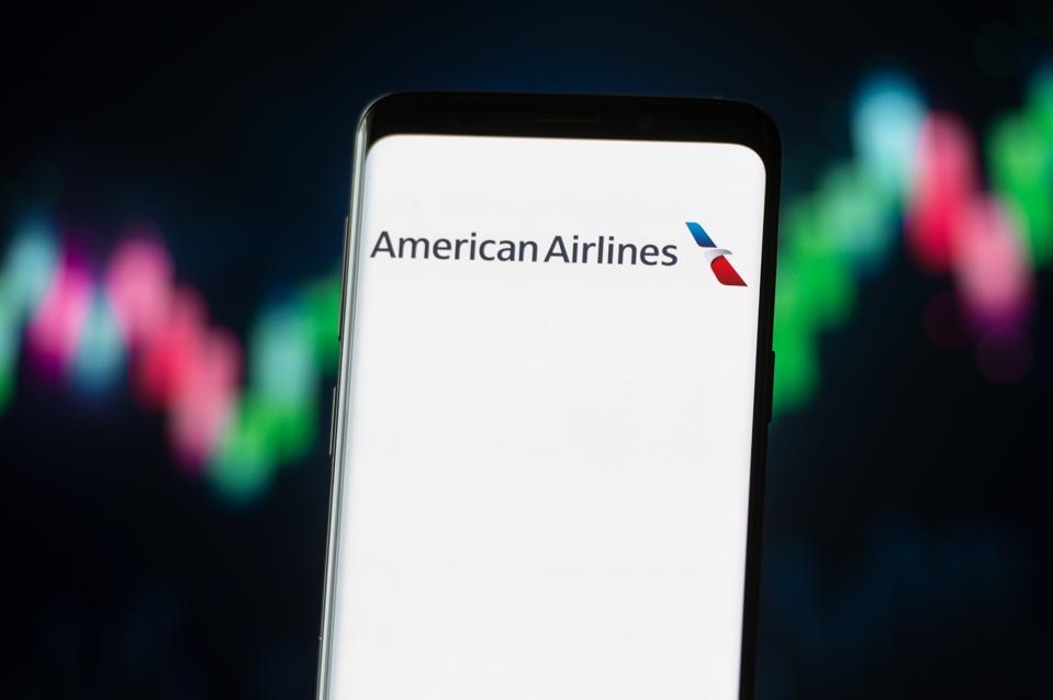 In this photo illustration an American Airlines logo seen...