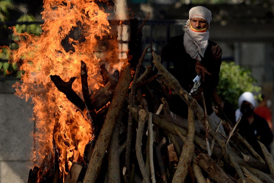 Crematorium worker in New Delhi, India. Coronavirus. Covid.