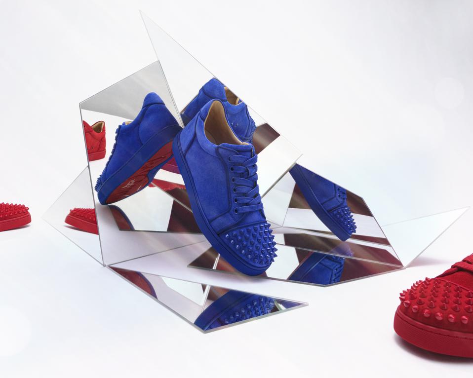 Christian Louboutin's signature sneakers in bright blue, and red.