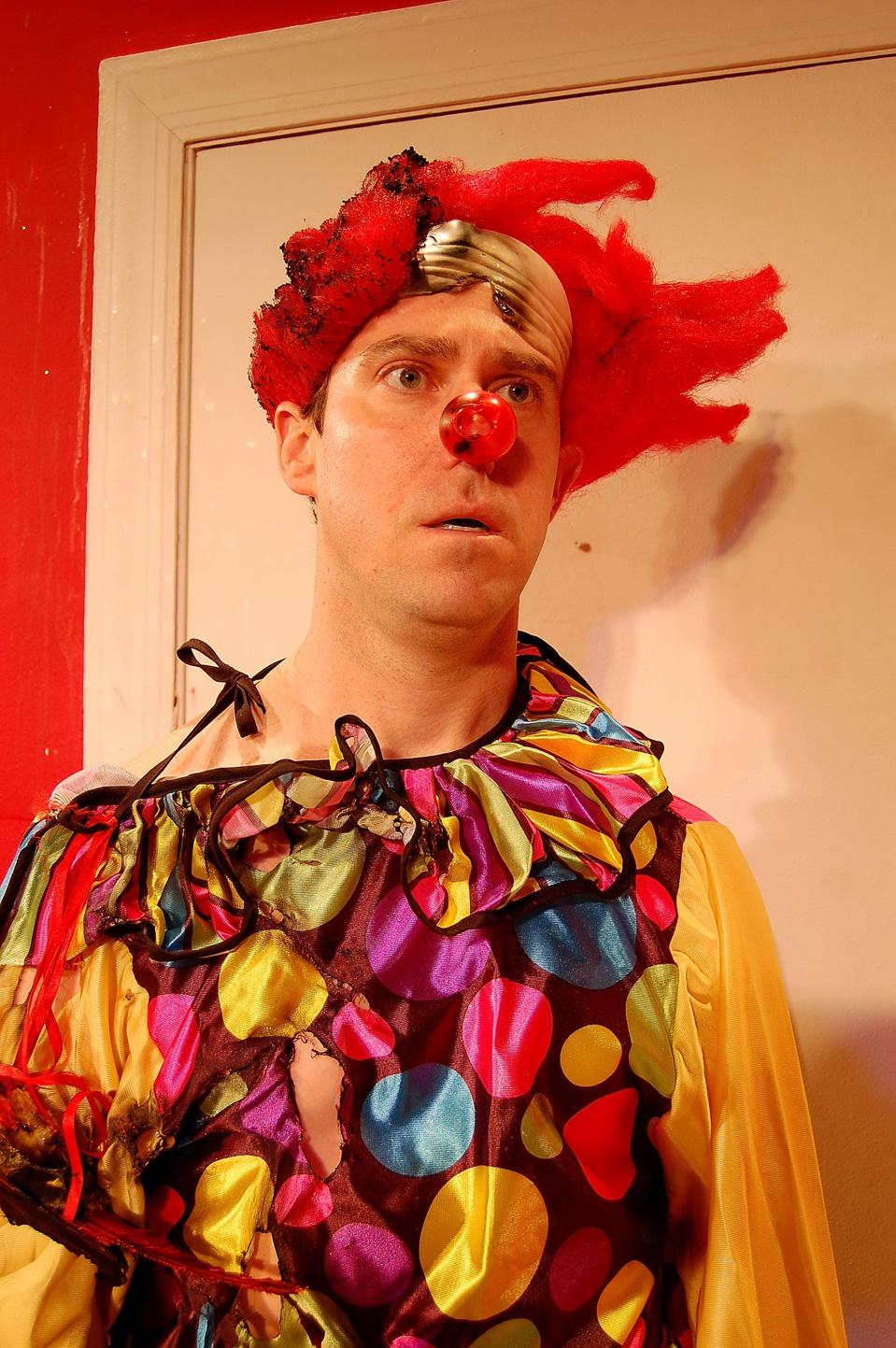 Man in clown suit disheveled