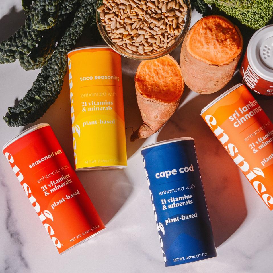 Enspice spice blends on a table with seeds, kale and sweet potato.