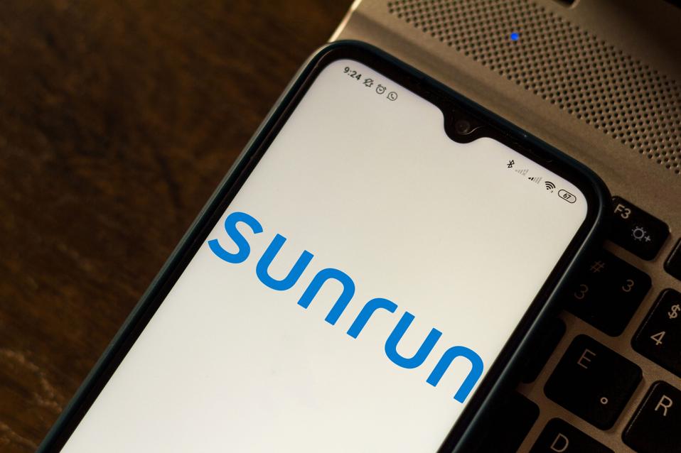 In this photo illustration the Sunrun logo seen displayed on...