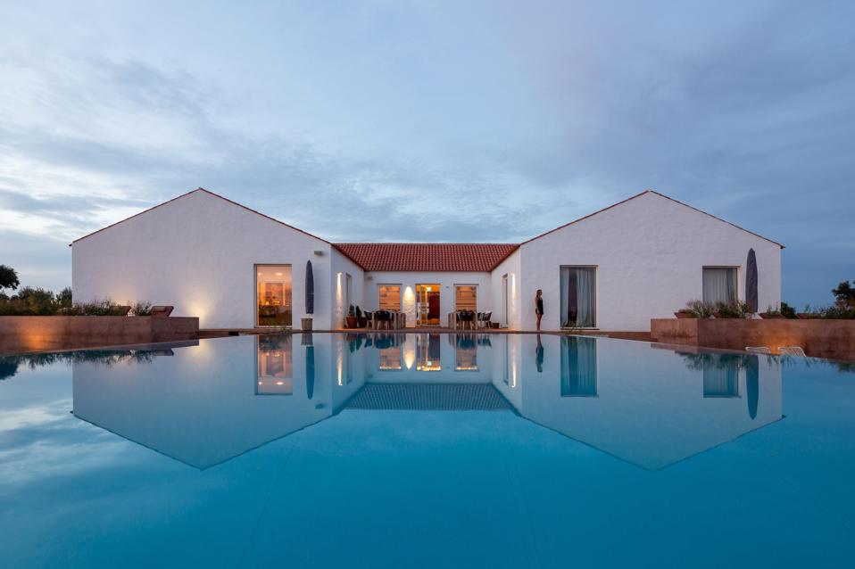 The swimming pool is in front of the private villa at Malhadinha Nova hotel in Portugal