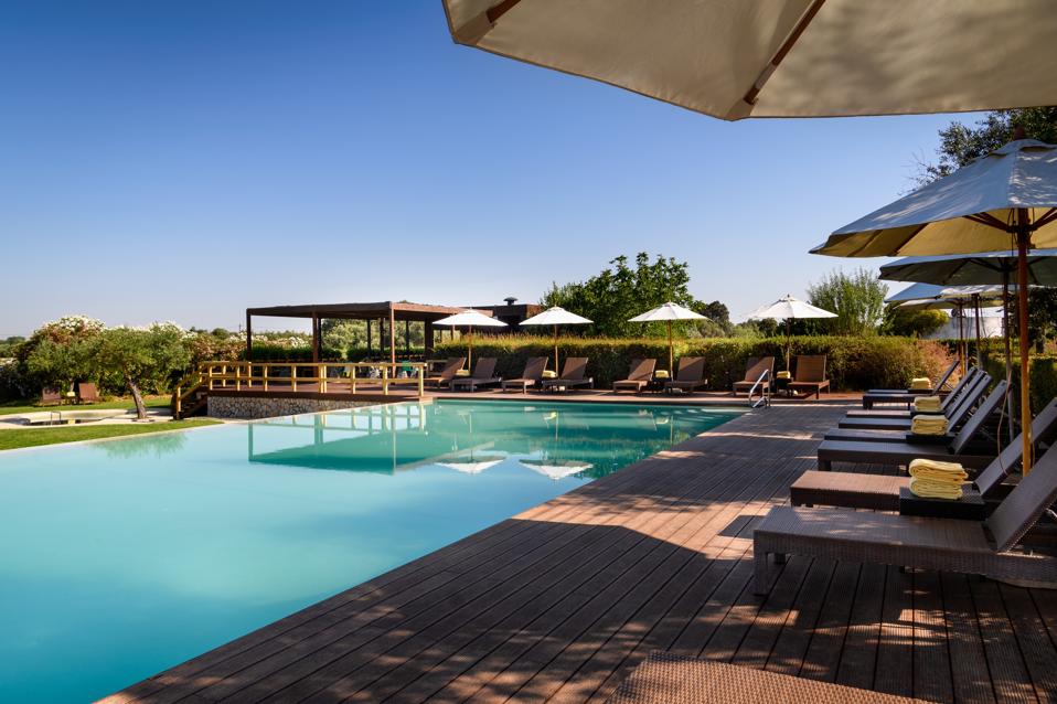 The pool at Convento do Espinheiro hotel in the Alentejo, Portugal, is sunny and shady