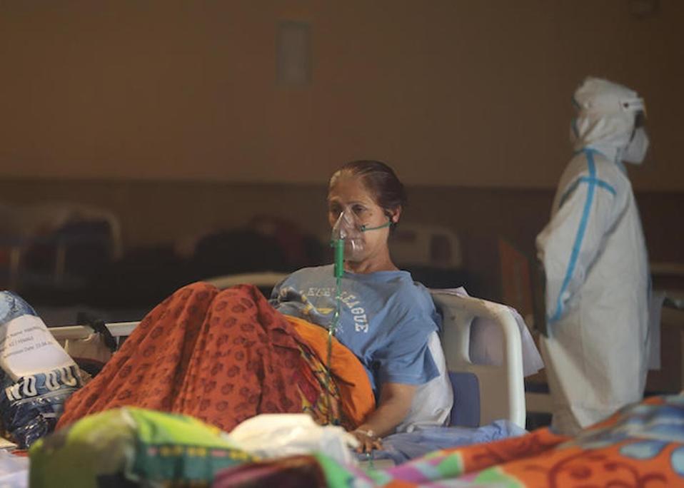 On May 2, 2021, a patient receives treatment in a banquet hall, temporarily converted into a COVID-19 emergency ward in New Delhi, India.
