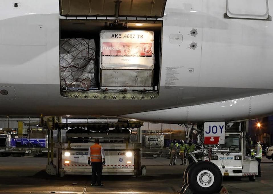 At the Indira Gandhi International Airport in New Delhi on May 18, 2021, ground staff prepare to unload a cargo plane filled with COVID-19 medical supplies sent by UNICEF.