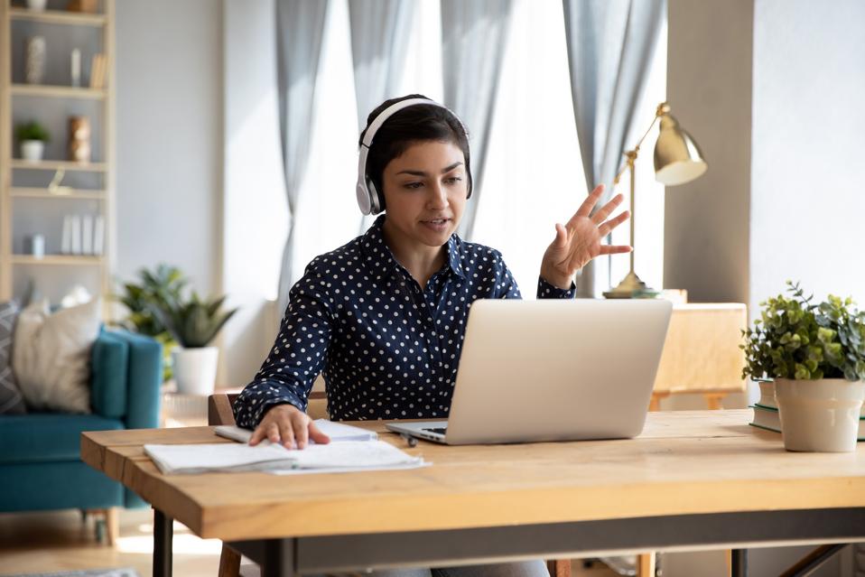 student wear headphones use laptop e-learning remotely by videocall