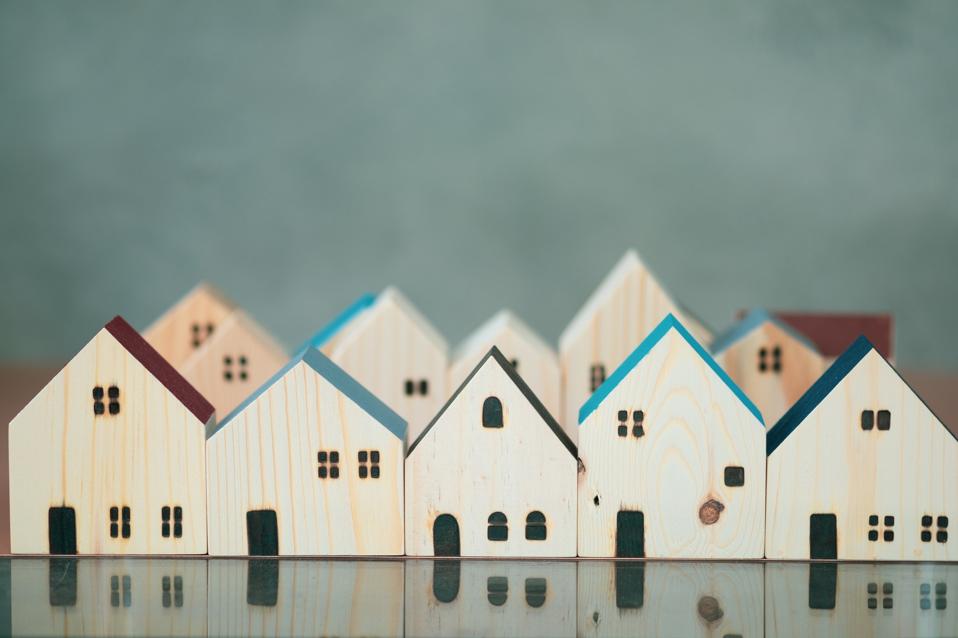 Village of miniature wooden. Concept of architecture in the city. Affordable housing. Construction of new buildings.