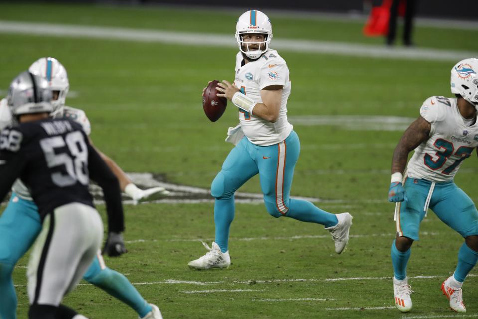 Miami Dolphins quarterback Ryan Fitzpatrick (14) looks to throw a pass against the Las Vegas Raiders during an NFL football game, Saturday, Dec. 26, 2020, in Las Vegas.The Dolphins won the game 26-25. (Jeff Haynes/AP Images for Panini)