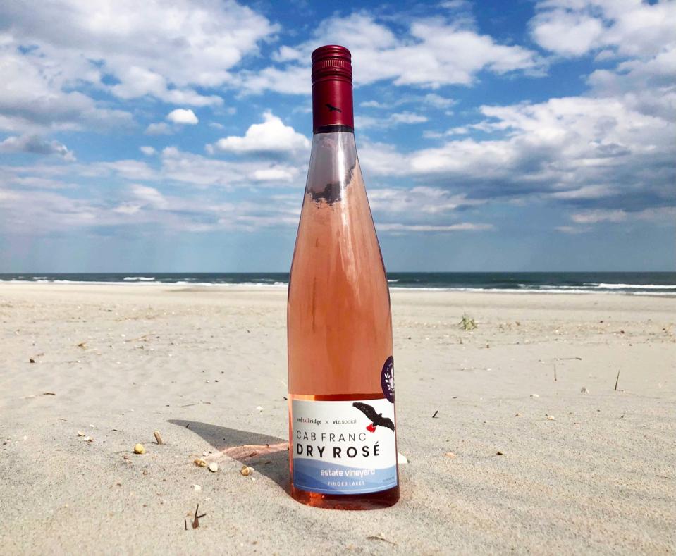 Bottle of Red Tail Ridge x Vin Social Cab Franc Dry Rosé on the beach
